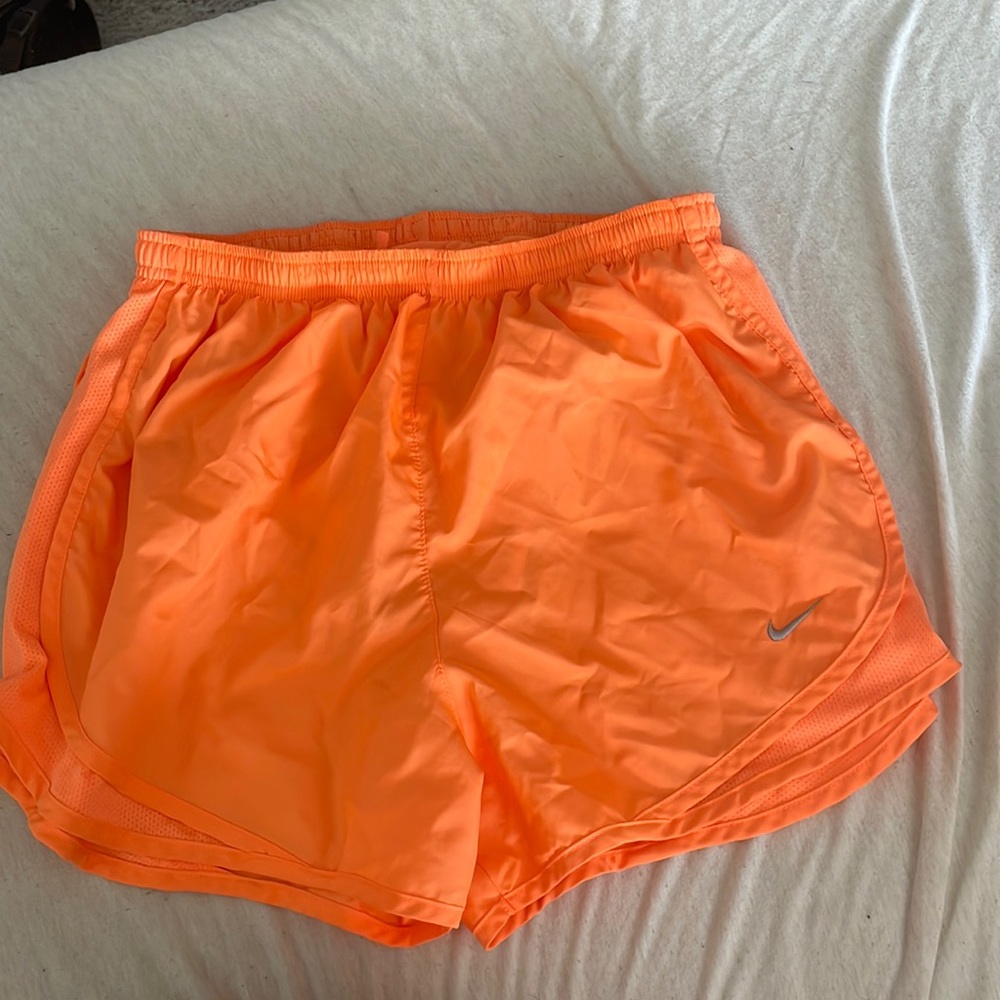 Orange Nike running shorts